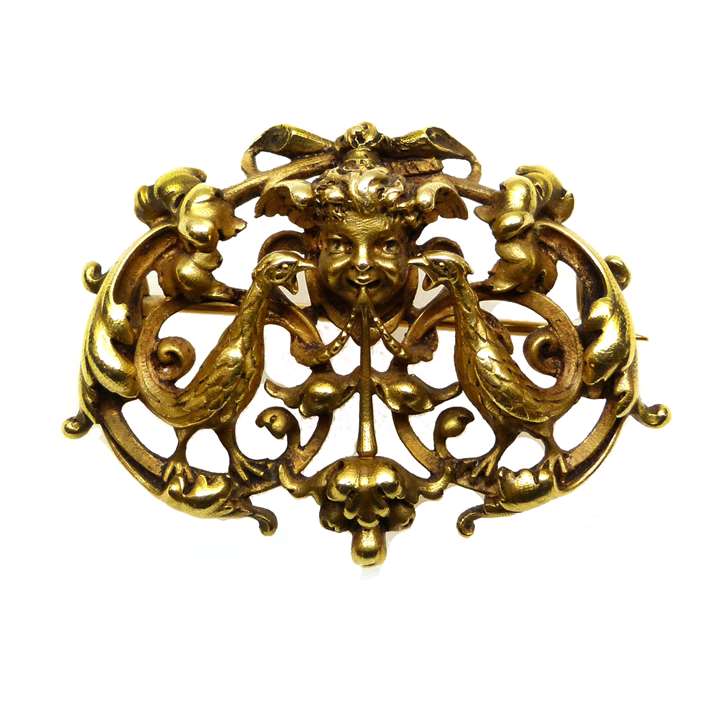 19th century openwork gold maskhead and scroll cartouche brooch